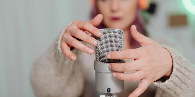 Person touching microphone