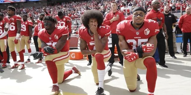 Colin Kaepernick takes a knee