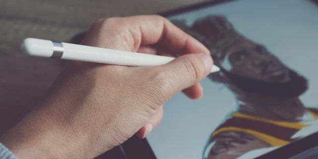 A person using a tablet and stylus to draw