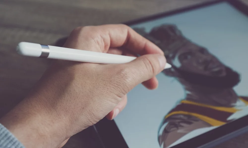 A person using a tablet and stylus to draw