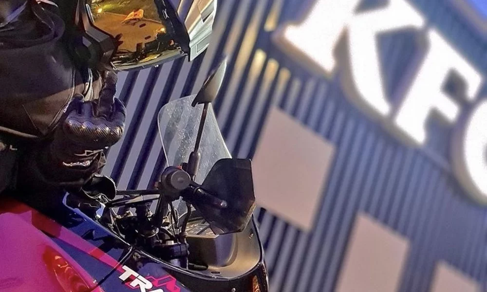 A motorcyclist holding up his middle finger