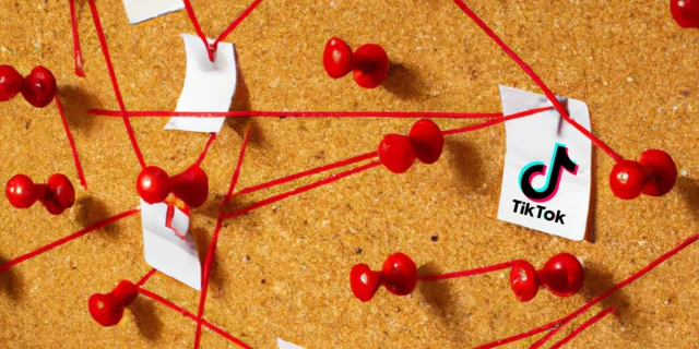 cork board with pieces of paper connected with red string, one piece has the TikTok logo on it